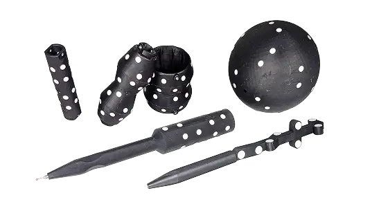 A set of black juggling clubs and balls with white polka dots arranged on a white background.