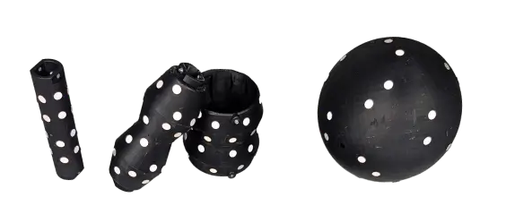 Black juggling clubs and a black juggling ball, all decorated with white polka dots, are displayed against a transparent background.