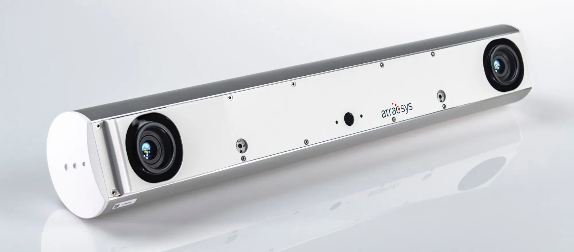 A sleek, rectangular sensor device with low latency tracking features, two round camera lenses at each end, branded with artraySys in the center, placed on a reflective white surface.