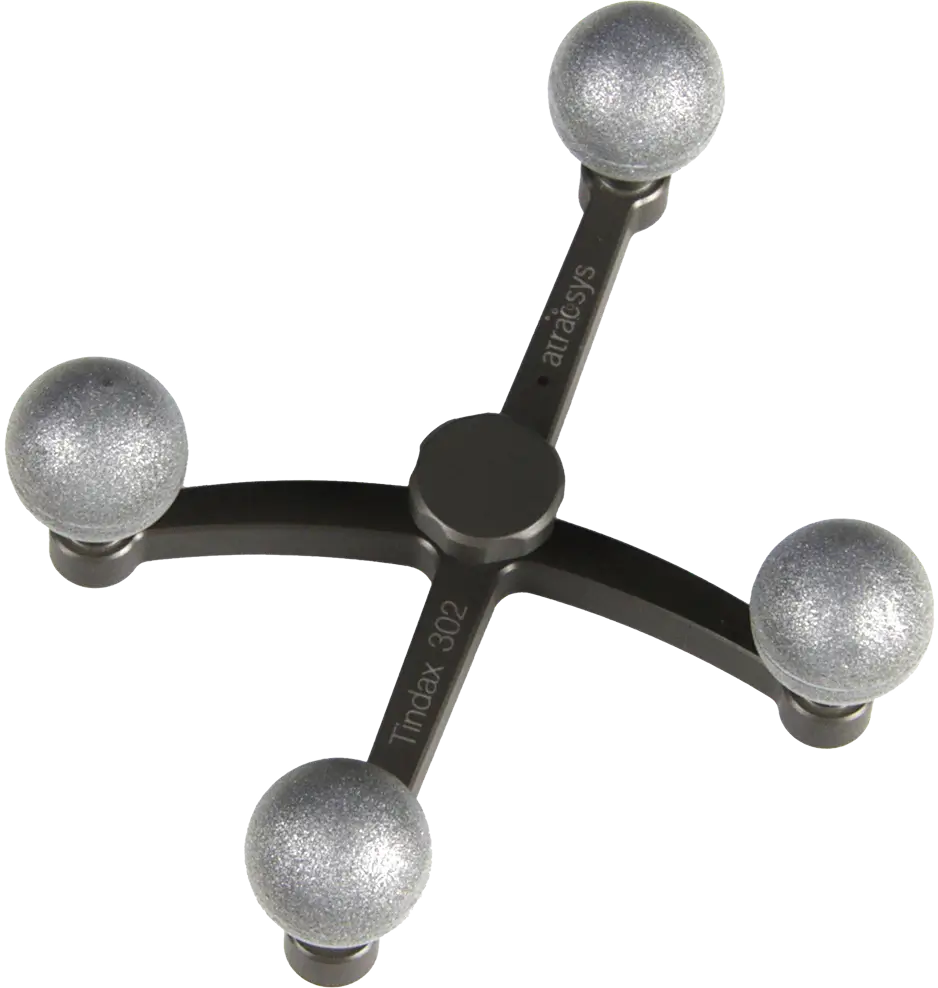 A black, X-shaped massage tool with four silver, spherical fiducials as round knobs at each end for applying pressure to muscles. The tool is labeled “Trimax 302” and “artacsys.”.