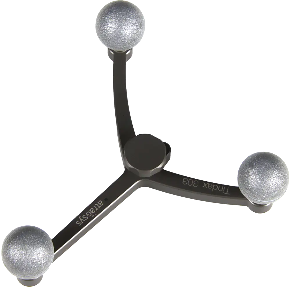 A three-pronged metallic device with spherical fiducials—silver spheres at each prong’s end—arranged in a Y-shape, labeled Tindax 303 and artecisys on the arms.